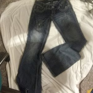 Amythist dark denim wash jeans. Slightly distresse